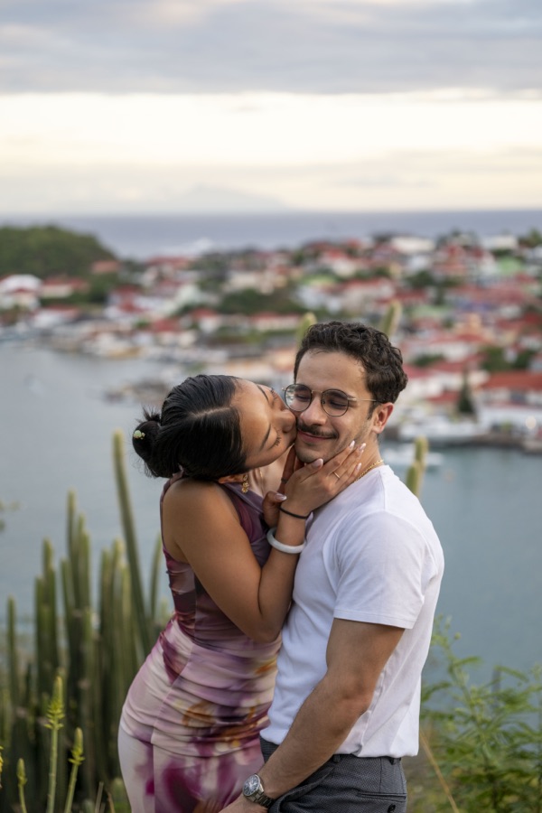 Fuanne kissing George on the cheek overlooking the harbor