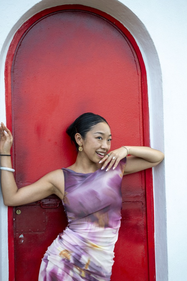Fuanne posing in a red archway