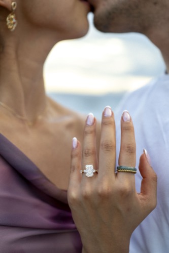 Close-up of engagement ring while kissing
